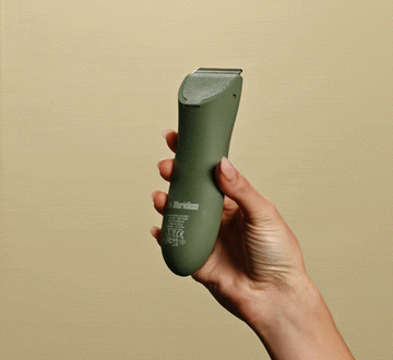 female putting on guard on trimmer